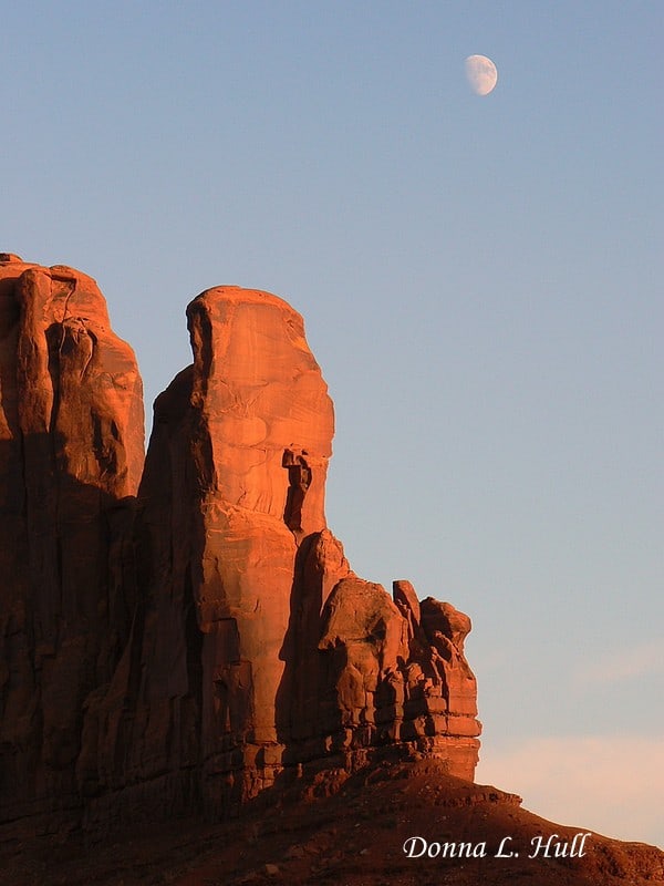 Photograph of the Moon Rising Over Monument Valley