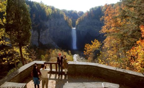 people posing on a platform in front of Taughannock Falls in the Finger Lakes, NY
