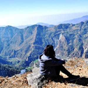 woman sitting overlooking the Himalayas