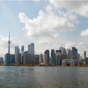 city skyline behind body of water