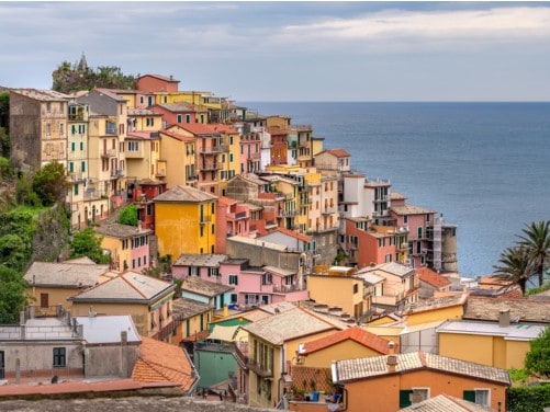shot of colorful cliff houses overlooking the sea