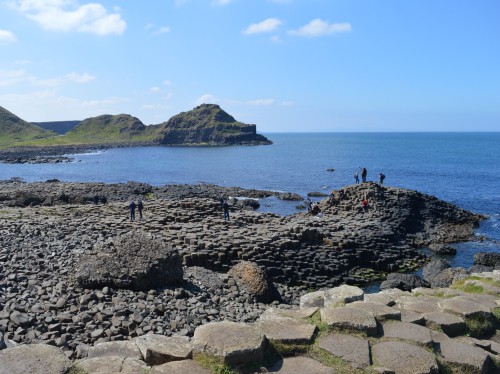 a walkway of rocks on the coast