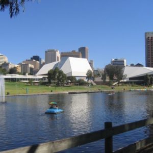 wide river with large buildings in the background