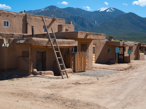 a group of earthen buildings with a ladder