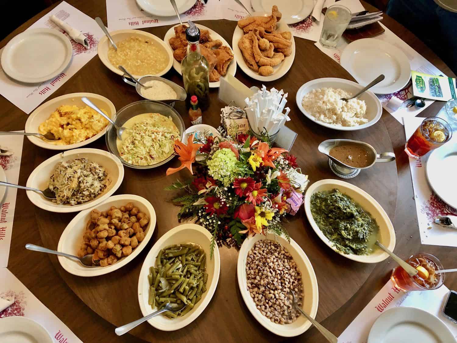 an assortment of vegetable side dishes on a dining room table lazy susan at Walnut Hills in Vicksburg Mississippi