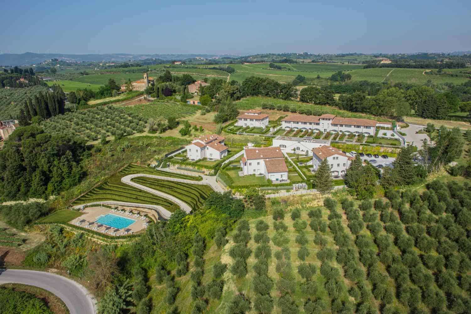 Aerial view of an Italian resort surrounded by olive trees and wine vineyards