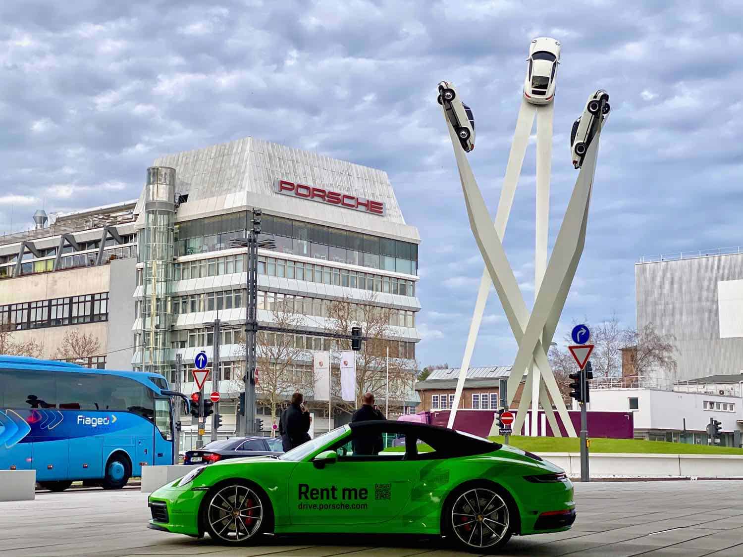 Exterior of the Porsche Museum in Stuttgart with a car sculpture in the front of the building