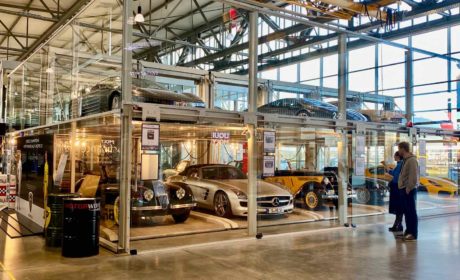 A car museum with cars housed in open bays protected by glass
