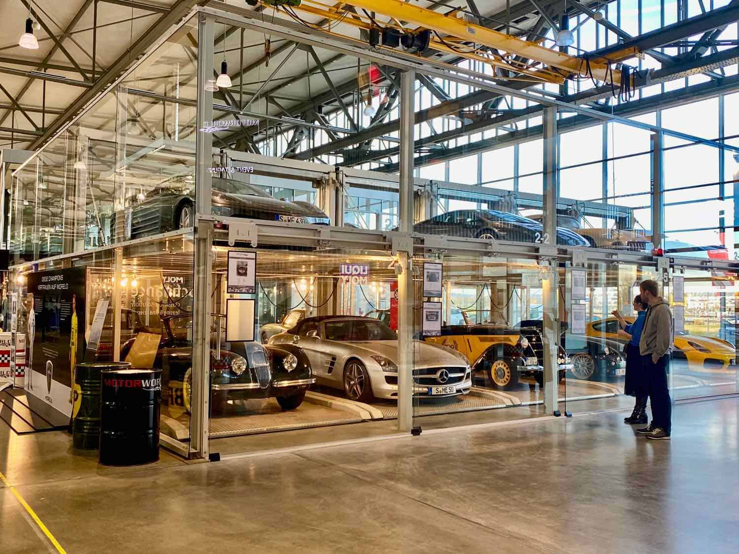 A car museum with cars housed in open bays protected by glass