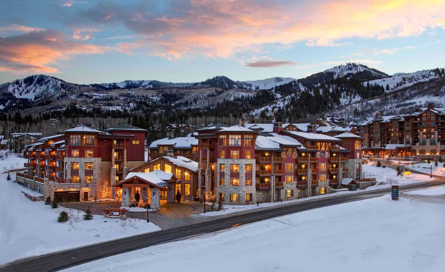 Buildings in a ski village surrounded by mountains and snow