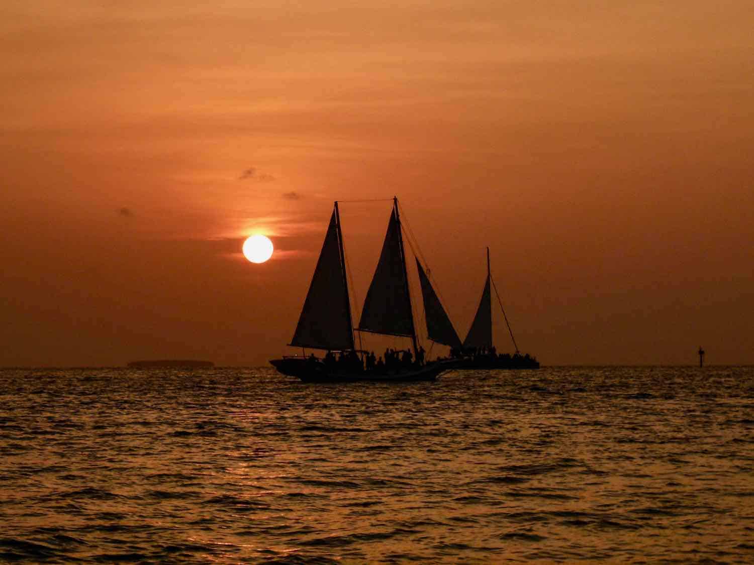 sailing ships at sunset