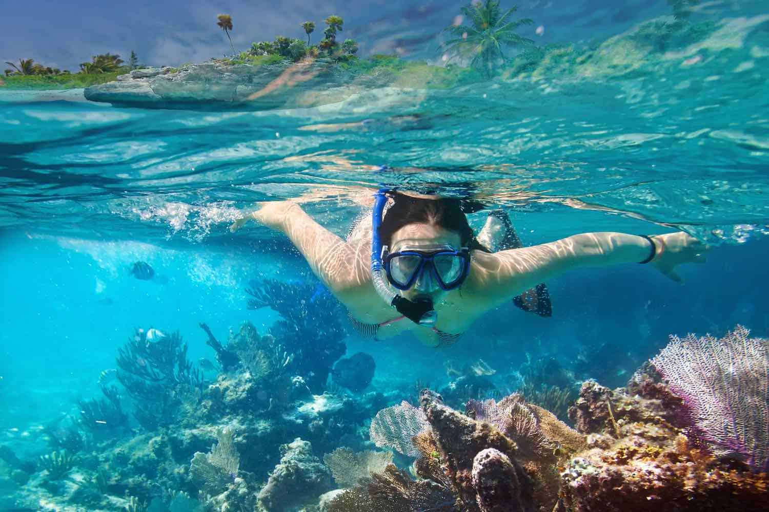 woman snorkeling underneath the water