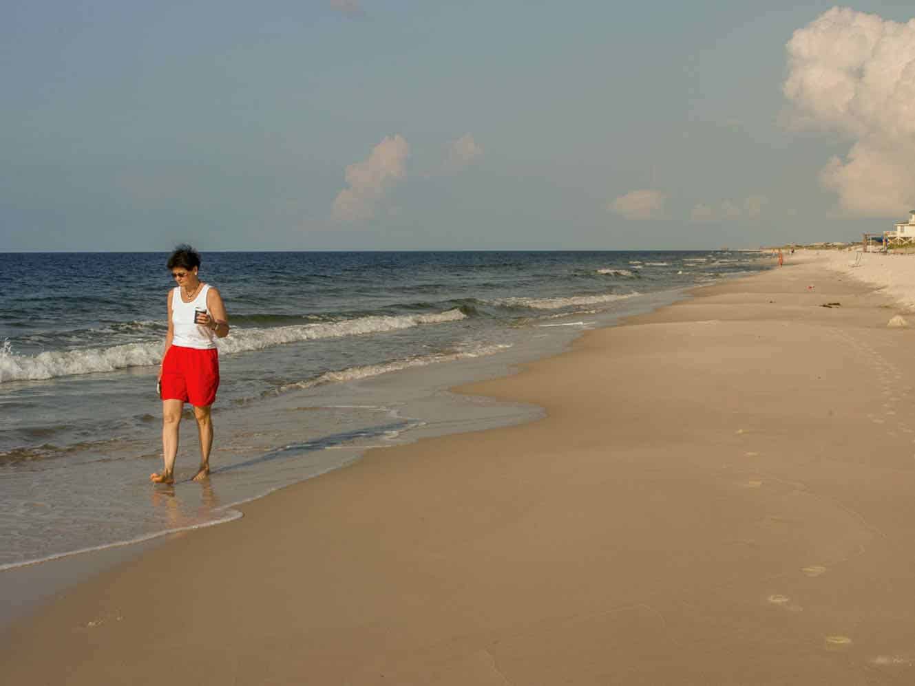 woman walking on a beach on the Alabama Gulf Coast