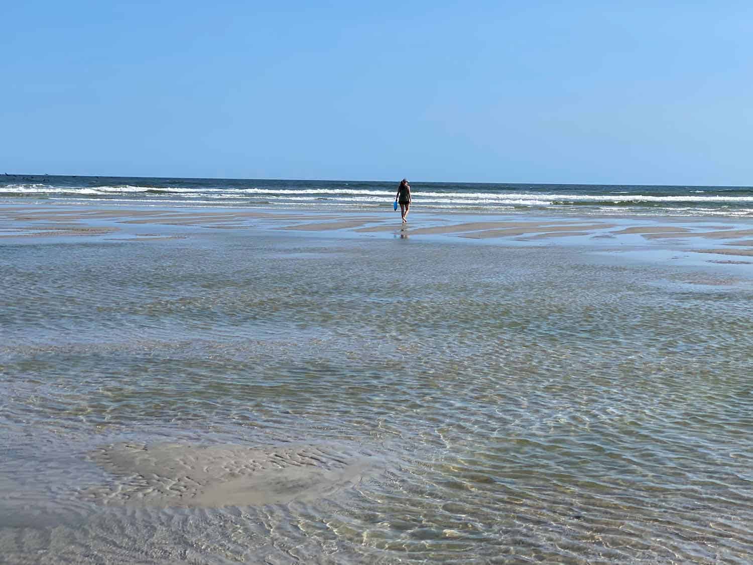 One person walking on an empty beach in Onslow County, NC.