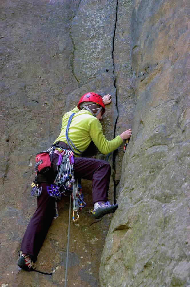 Rock climber climbing a rock boulder