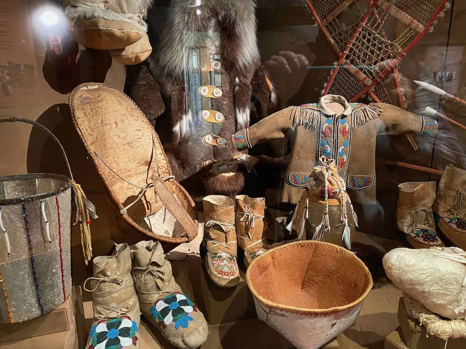 Native Alaskan museum pieces: shirt, boots, snowshoe