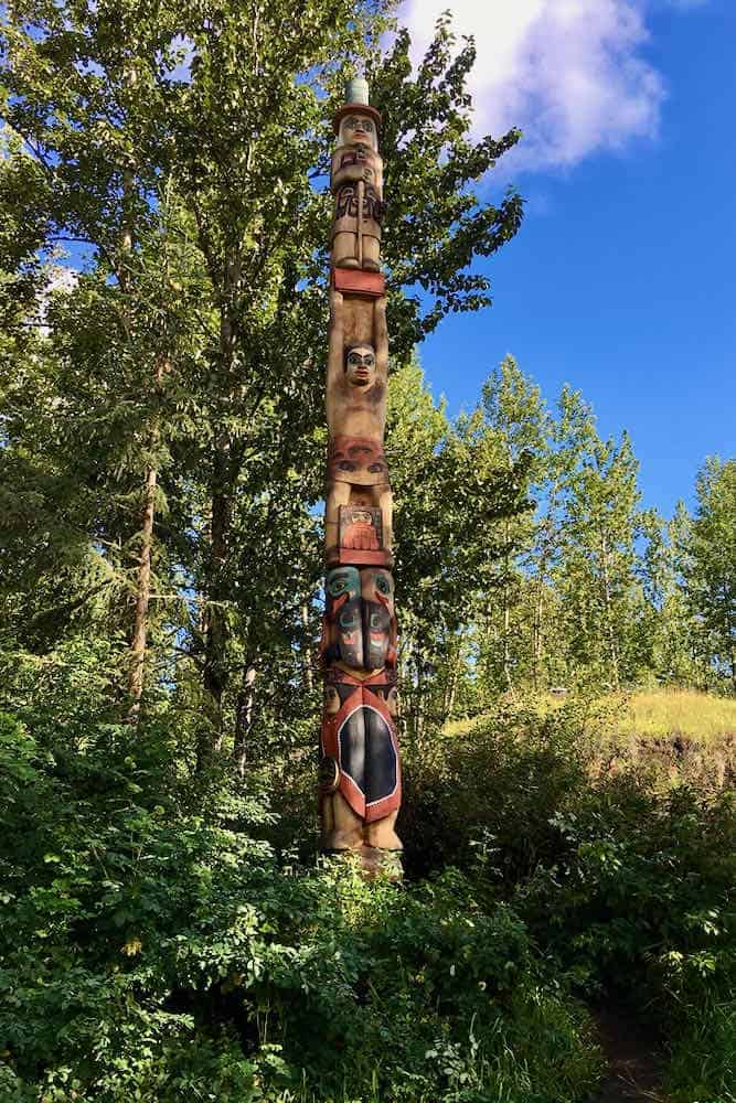 totem pole with trees behind it