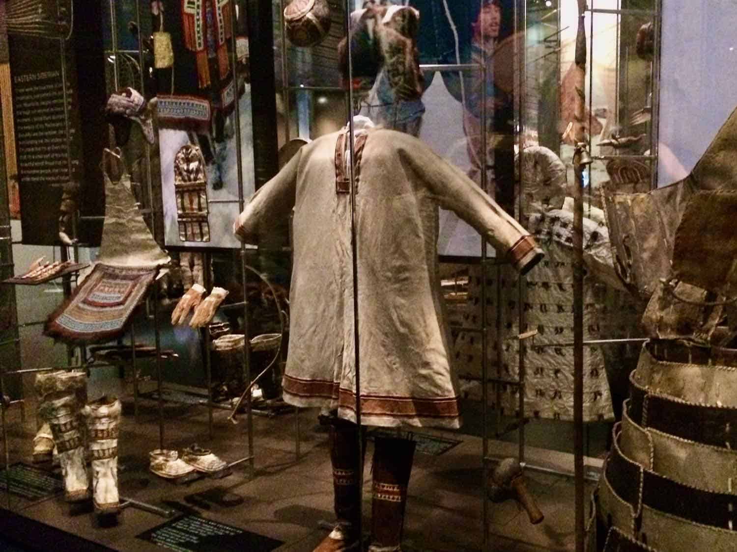 Museum display containing clothing, boots, gloves of indigenous people in Alaska
