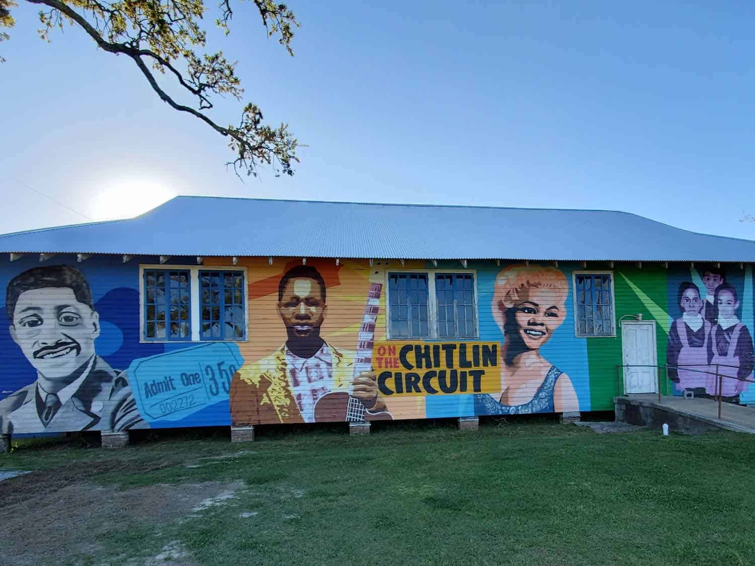 Mural of black entertainers on the side of a house