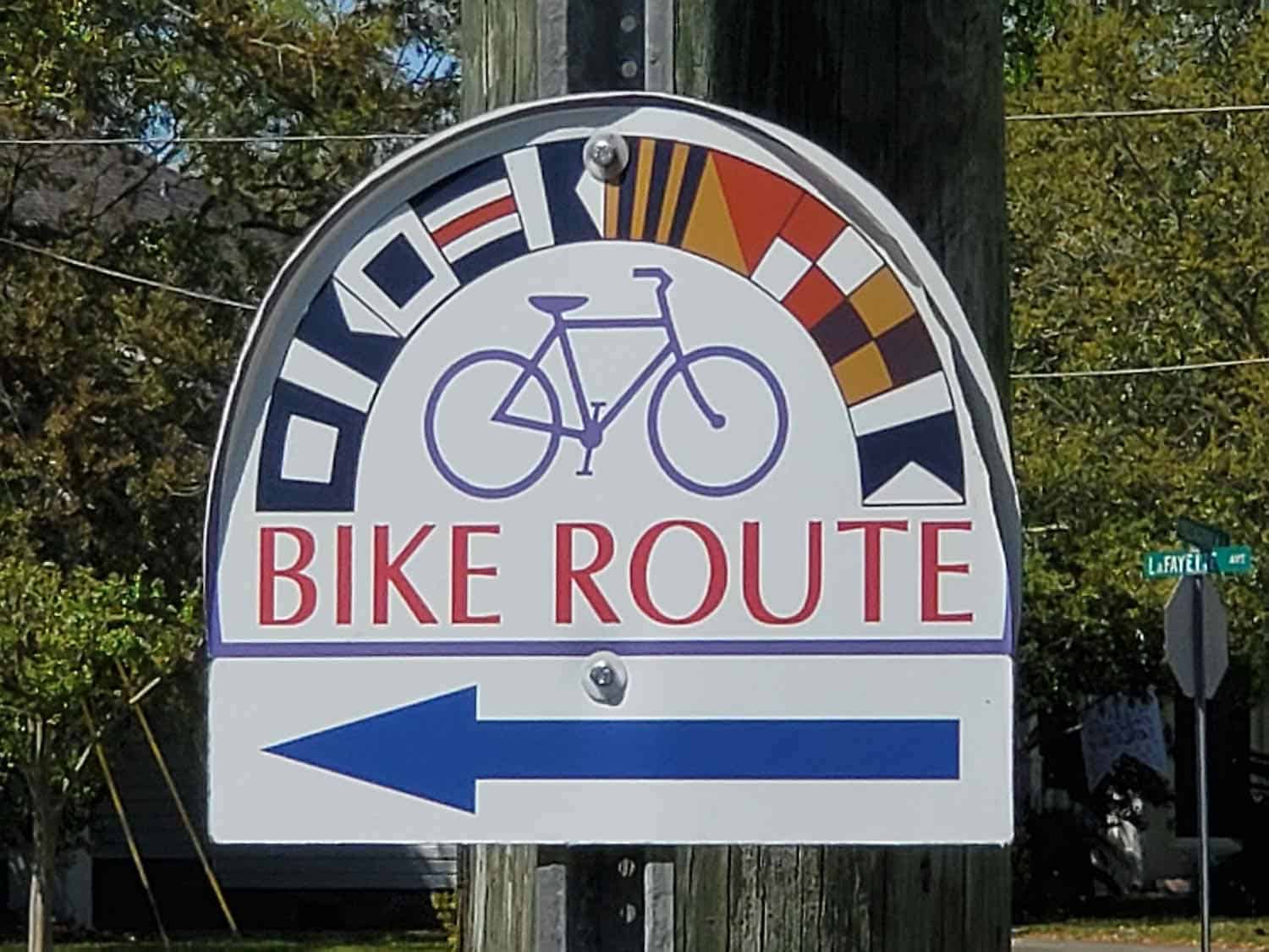 A sign with an arrow pointing to a bike path