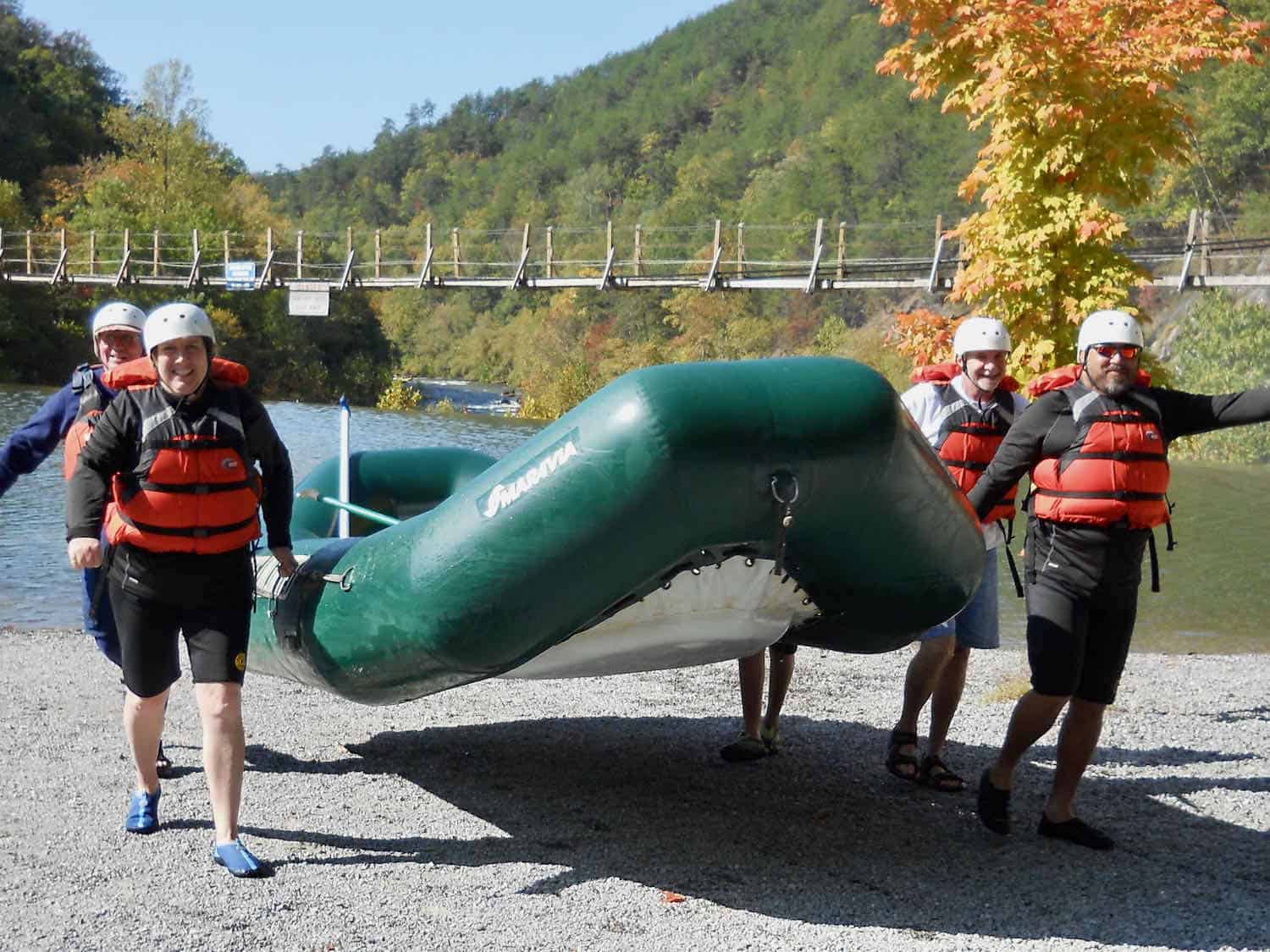 Four people holding a raft after an Ocoee River rafting adventure