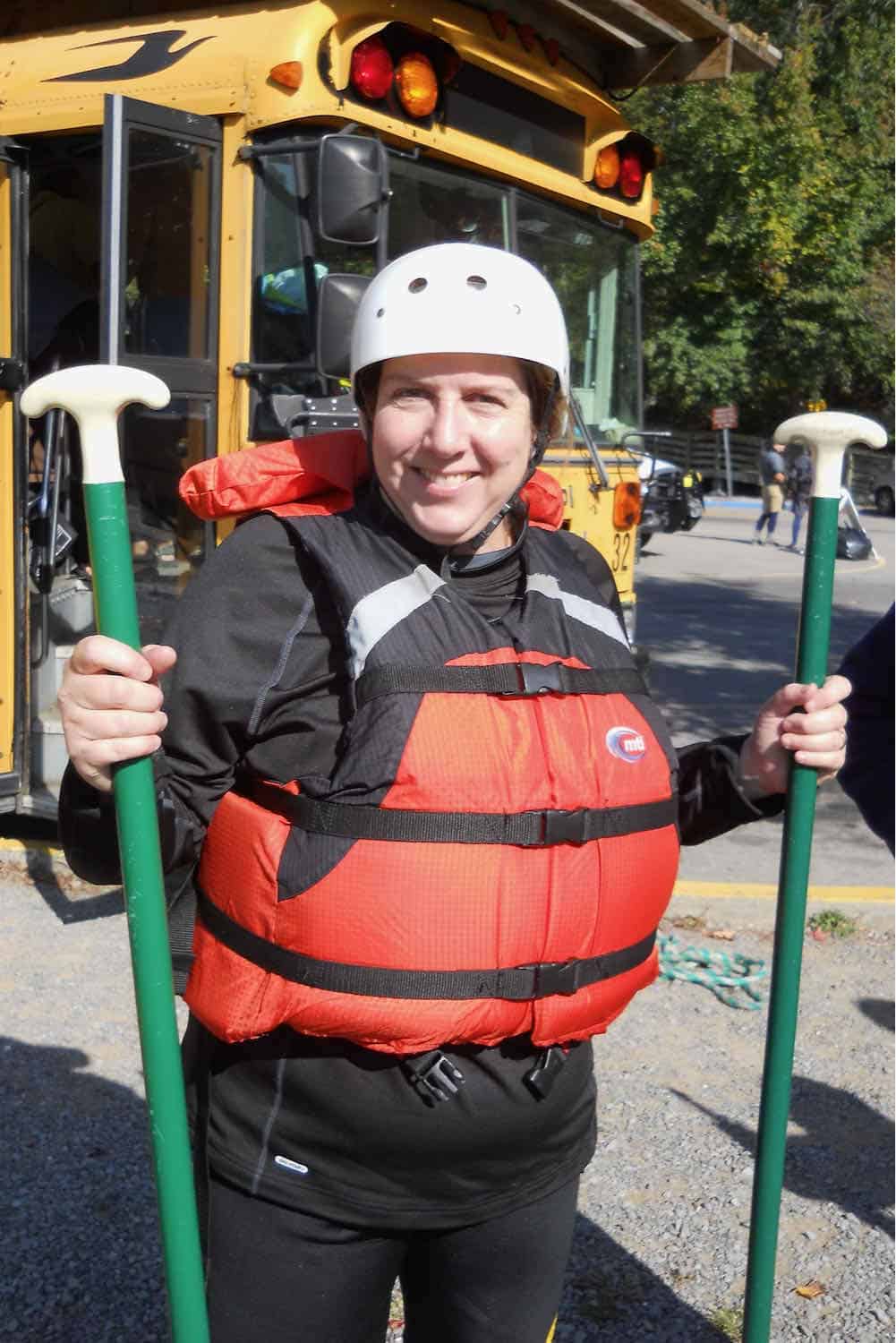 woman holding paddles getting ready to raft the Ocoee River in Tennessee