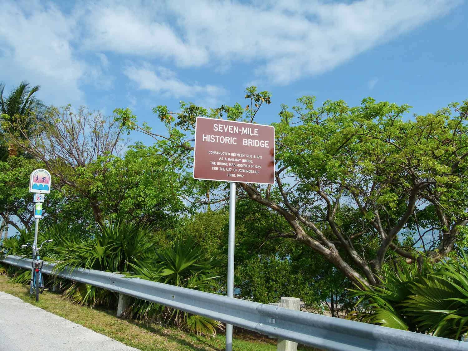 Seven-Mile Historic Bridge sign surrounded by trees in the Florida Keys