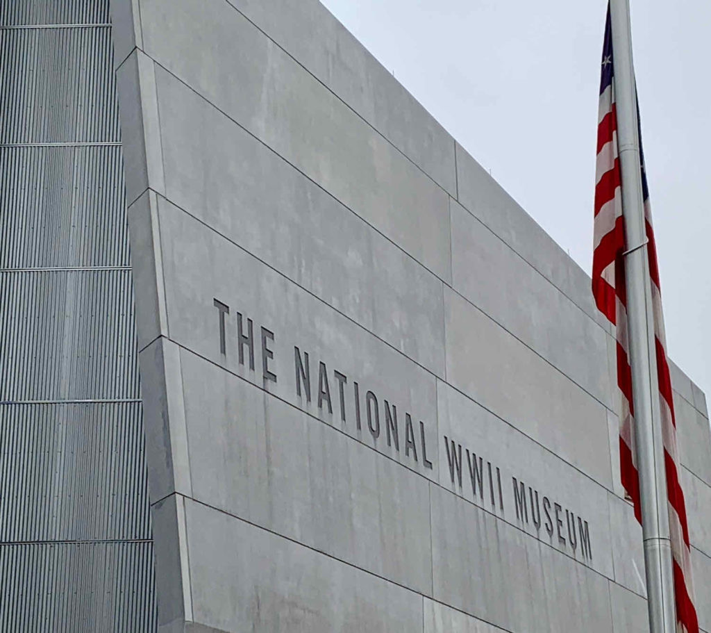 US flag next to the concrete face of The National WWII Museum