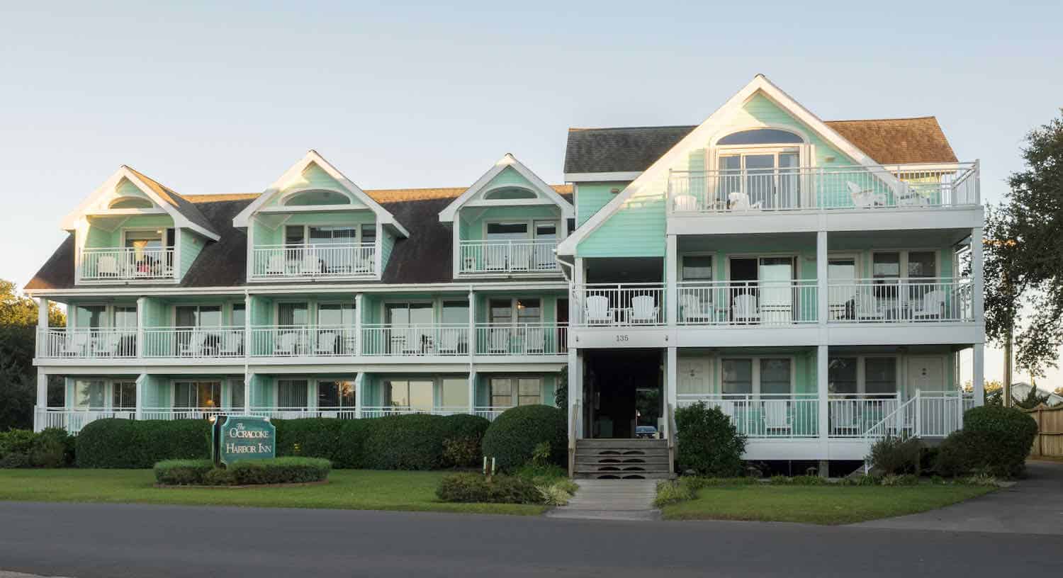 The green and white building of Ocracoke Harbor Inn.