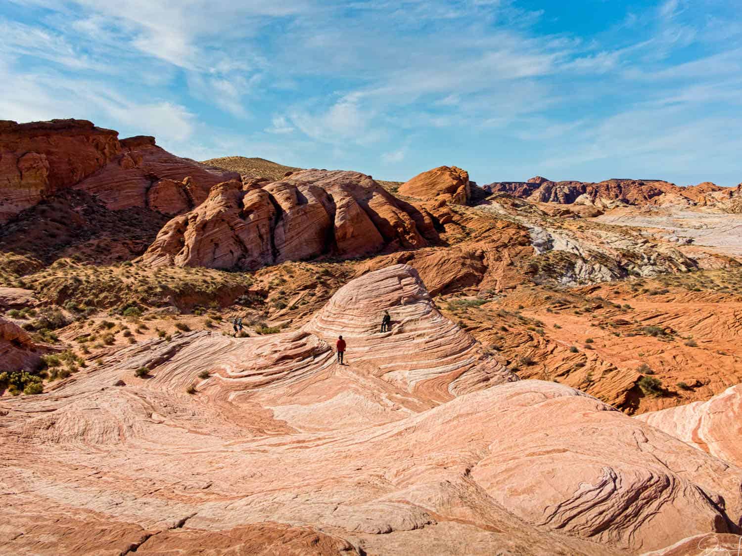 A series of undulating orange rocks known as The Fire Wave in Valley of Fire State Park Nevada.