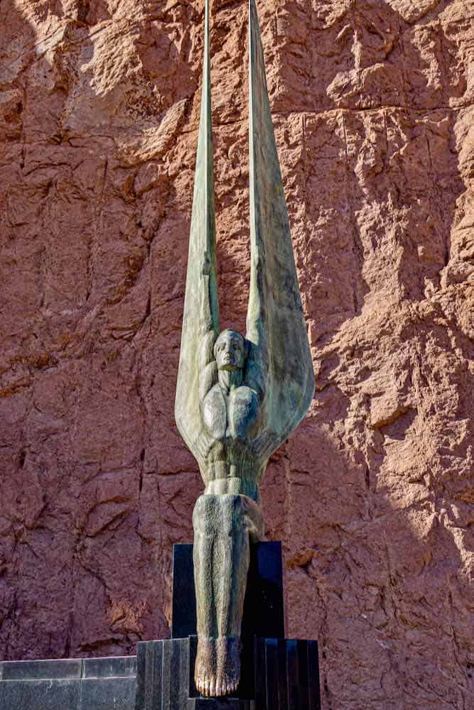 A sculpture piece that resembles a winged figure mounted near Hoover Dam.
