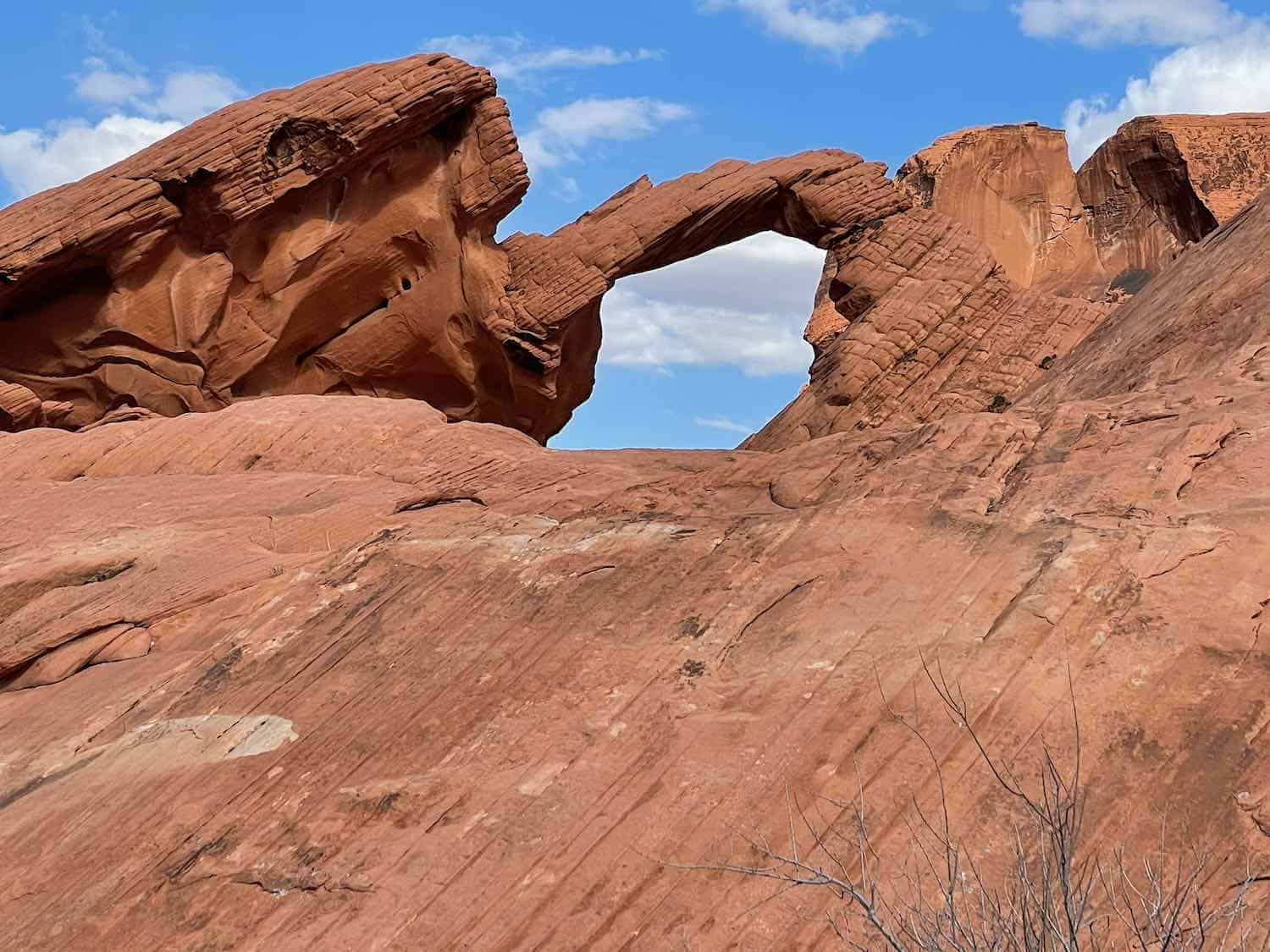 An arch in red rocks known as Arch Rock in Valley of Fire State Park Nevada.