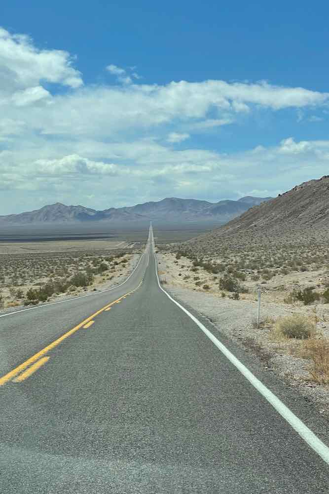 Two-lane highway leading into Furnace Creek on a two day itinerary in Death Valley 
