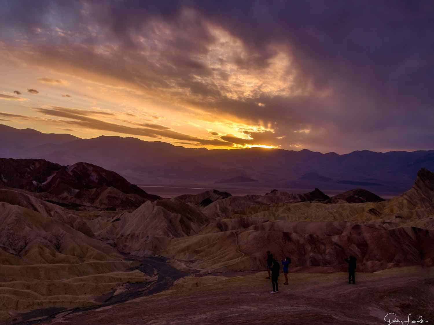 The gold and purple afterglow of a sunset at Zabriskie Point on a Death Valley weekend trip.